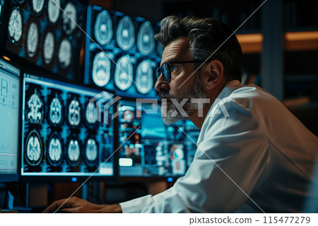 Middle-aged doctor checking brain x-ray results on a monitor at hospital. Middle-aged doctor checking brain x-ray results on a monitor at hospital. 115477279