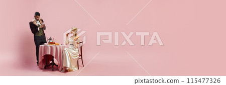Digital Age Meets Victorian Grace. Gentleman taking photo of beautiful young woman with mobile phone against pink studio background Digital Age Meets Victorian Grace. Gentleman taking photo of beautiful young woman with mobile phone against pink studio background 115477326