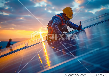 A technician is installing solar panels at a photovoltaic power station. 115477473