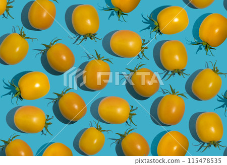 Yellow cherry tomato pattern on a blue background. Bright vegetable. Vitamin food 115478535