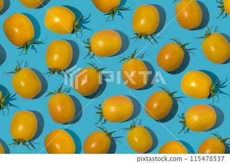Yellow cherry tomato pattern on a blue background. Bright vegetable. Vitamin food Yellow cherry tomato pattern on a blue background. Bright vegetable. Vitamin food 115478537