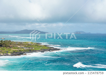 A small island situated in the center of a vast body of water A small island situated in the center of a vast body of water 115478759