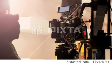 Filmmaker crew team with professional cinema equipment and video camera on the set. Film director and crew making commercial content advertising in studio. Technique of modern filming and advertising. Filmmaker crew team with professional cinema equipment and video camera on the set. Film director and crew making commercial content advertising in studio. Technique of modern filming and advertising. 115478941