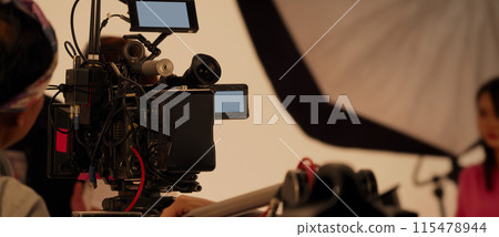 Filmmaker crew team with professional cinema equipment and video camera on the set. Film director and crew making commercial content advertising in studio. Technique of modern filming and advertising. Filmmaker crew team with professional cinema equipment and video camera on the set. Film director and crew making commercial content advertising in studio. Technique of modern filming and advertising. 115478944