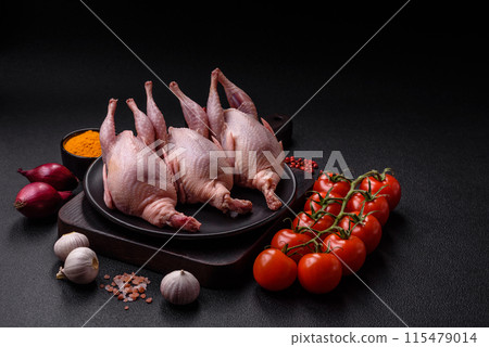Whole raw quails with salt, spices and herbs on a dark concrete background Whole raw quails with salt, spices and herbs on a dark concrete background 115479014