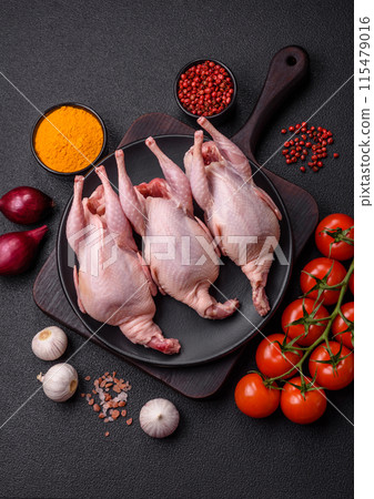 Whole raw quails with salt, spices and herbs on a dark concrete background Whole raw quails with salt, spices and herbs on a dark concrete background 115479016