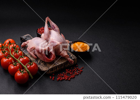 Whole raw quails with salt, spices and herbs on a dark concrete background 115479020