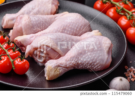Raw chicken legs with salt, spices and herbs 115479060
