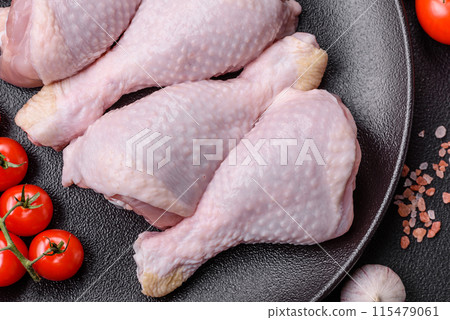 Raw chicken legs with salt, spices and herbs Raw chicken legs with salt, spices and herbs 115479061