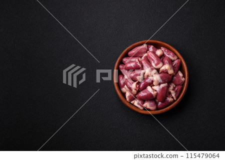 Raw chicken hearts with salt, spices and herbs 115479064