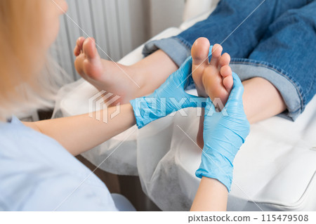 Professional foot massage for woman at a beauty salon. 115479508