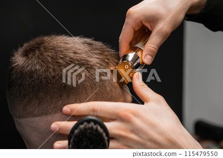 Close up barber shapes mans hair on the forehead Close up barber shapes mans hair on the forehead 115479550