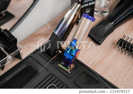 Hair clippers and trimmers are on the table in the barbershop Hair clippers and trimmers are on the table in the barbershop 115479557