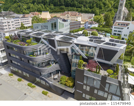 Modern Design Building with solar panel on roof top in Vaduz, Liechtenstein. Reuse and restore. Renewable energy concept Modern Design Building with solar panel on roof top in Vaduz, Liechtenstein. Reuse and restore. Renewable energy concept 115479940