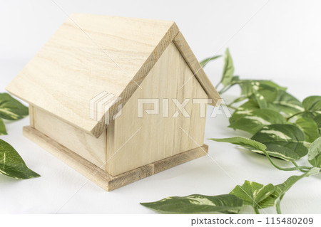 Toy wooden house and fake greenery Toy wooden house and fake greenery 115480209
