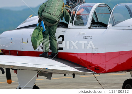 Pilot getting out of the cockpit Pilot getting out of the cockpit 115480212