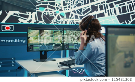 Woman call center operator guiding delivery truck drivers on different routes to avoid traffic and help with express shipment. Agency uses surveillance CCTV video and gps tracking. Camera B. 115481308