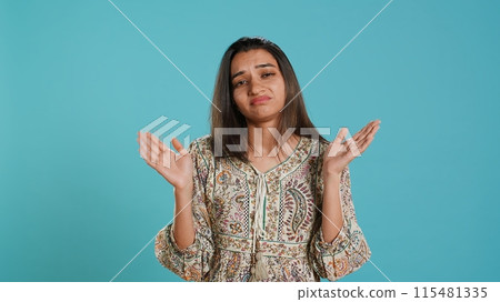 Lazy woman lacking interest for anything, feeling depressed, looking lifeless, isolated over studio background. Portrait of bored indian person suffering from tiredness, feeling exhausted, camera A Lazy woman lacking interest for anything, feeling depressed, looking lifeless, isolated over studio background. Portrait of bored indian person suffering from tiredness, feeling exhausted, camera A 115481335