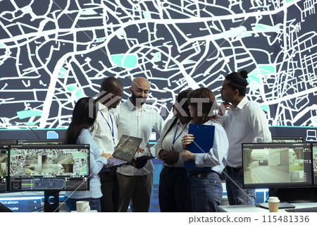 Diverse team of operators analyzing parcel awb and logistics to ensure order tracking service within the delivery app. Employee following truck drivers via gps coordinates on digital map. 115481336