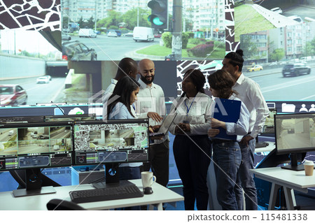 Team of diverse operators uniting forces to ensure express shipping, finding new routes to avoid urban traffic. Agency operating on CCTV security cameras footage and gps navigation. Team of diverse operators uniting forces to ensure express shipping, finding new routes to avoid urban traffic. Agency operating on CCTV security cameras footage and gps navigation. 115481338