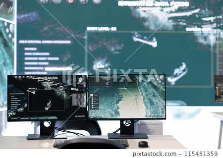 Government agency general headquarters empty command post with big screen monitoring satellite radar footage for threat oversight. Federal army power base with high tech to accomplish missions. Government agency general headquarters empty command post with big screen monitoring satellite radar footage for threat oversight. Federal army power base with high tech to accomplish missions. 115481359
