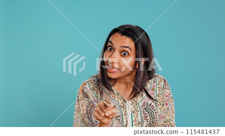 Upset indian person fighting with friend, doing scolding gesturing, isolated over studio backdrop. Annoyed woman arguing with opponent during discussion, doing admonishing hand gestures, camera B Upset indian person fighting with friend, doing scolding gesturing, isolated over studio backdrop. Annoyed woman arguing with opponent during discussion, doing admonishing hand gestures, camera B 115481437