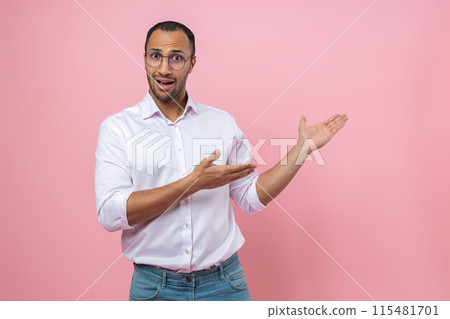 Confused man in white shirt presenting advertisement area 115481701