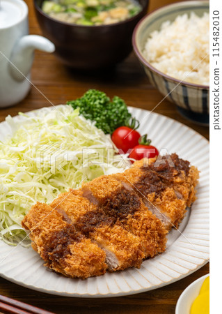 Pork cutlet and other dishes on the table 115482010