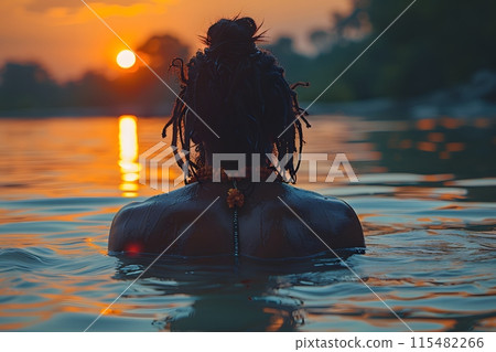 Guru with Dreadlocks Wading in Water 115482266