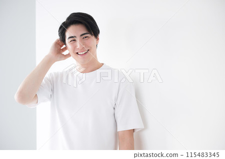 Asian (Japanese) man touching his hair. Refreshing hair removal and skin care image. Looking at the camera. 115483345