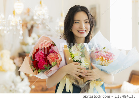 Young woman holding a bouquet of flowers Young woman holding a bouquet of flowers 115484135