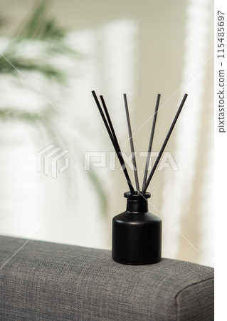 Aroma diffuser bottle with sticks in living room 115485697