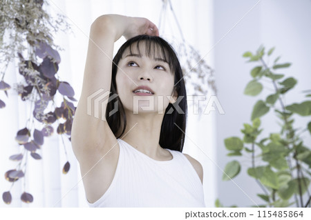 穿著背心的年輕女子檢查腋窩 穿著背心的年輕女子檢查腋窩 115485864
