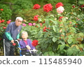 Seniors taking photos in a rose garden 115485940