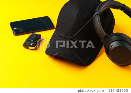 Baseball hat against yellow background in studio 115485960