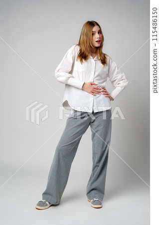 Young Woman in White Shirt Posing for Picture Young Woman in White Shirt Posing for Picture 115486150