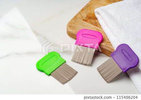 Anti lice combs and towel on white background Anti lice combs and towel on white background 115486204