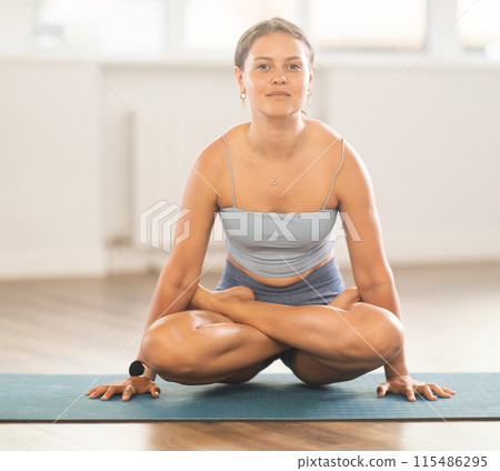 Experienced woman yoga trainer performing different youga pose on mat 115486295