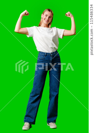 Happy Young Woman Raising Fists against green background Happy Young Woman Raising Fists against green background 115486334