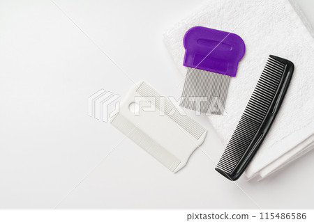 Anti lice combs and towel on white background Anti lice combs and towel on white background 115486586