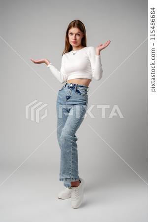 Young Woman in Blue Top Holding Out Hands Young Woman in Blue Top Holding Out Hands 115486684