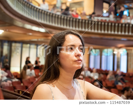 Portrait of a young woman in mezzanine theater 115487039