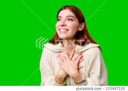 A woman wearing a skirt and sweater is striking a pose for a picture, standing confidently in front of the camera. A woman wearing a skirt and sweater is striking a pose for a picture, standing confidently in front of the camera. 115487135