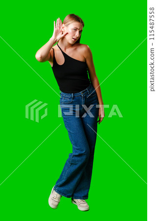 Young Woman in Black Top Holding Hand to Ear Young Woman in Black Top Holding Hand to Ear 115487558