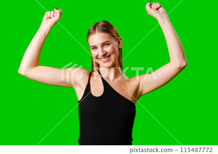Happy Young Woman Raising Fists against green background Happy Young Woman Raising Fists against green background 115487772