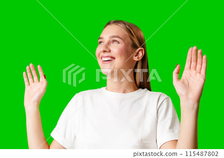 Young Woman in White T-shirt Making a Surprised Face Young Woman in White T-shirt Making a Surprised Face 115487802