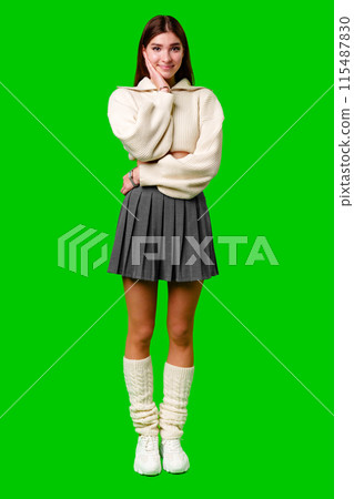 A woman wearing a white sweater is smiling happily. A woman wearing a white sweater is smiling happily. 115487830