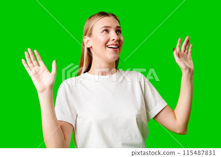 Young Woman in White T-shirt Making a Surprised Face Young Woman in White T-shirt Making a Surprised Face 115487831