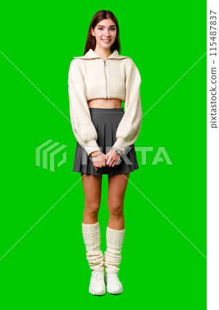 Young Woman Smiling in Front of a Green Screen Wearing Casual Clothing Young Woman Smiling in Front of a Green Screen Wearing Casual Clothing 115487837