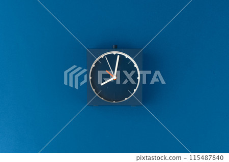Top view of alarm clock on classic blue background Top view of alarm clock on classic blue background 115487840